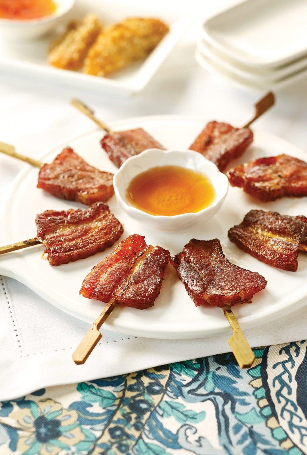 Bacon Lollipops on a plate with dipping sauce